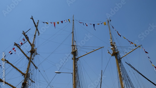 sailing ship's mast with various country flags
