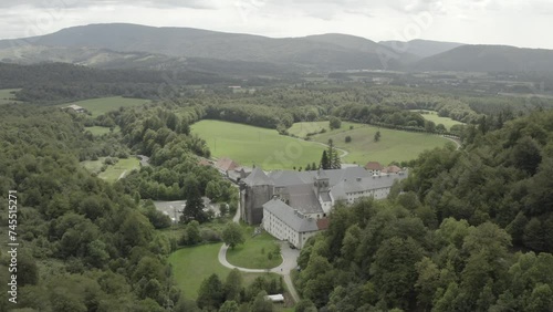 Royal Collegiate of Roncesvalles or Roncevaux and surrounding landscape, Navarre in Spain. Aerial forward photo