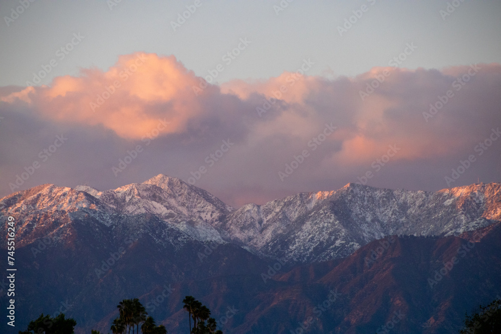 Snowy mountaintops at sunset