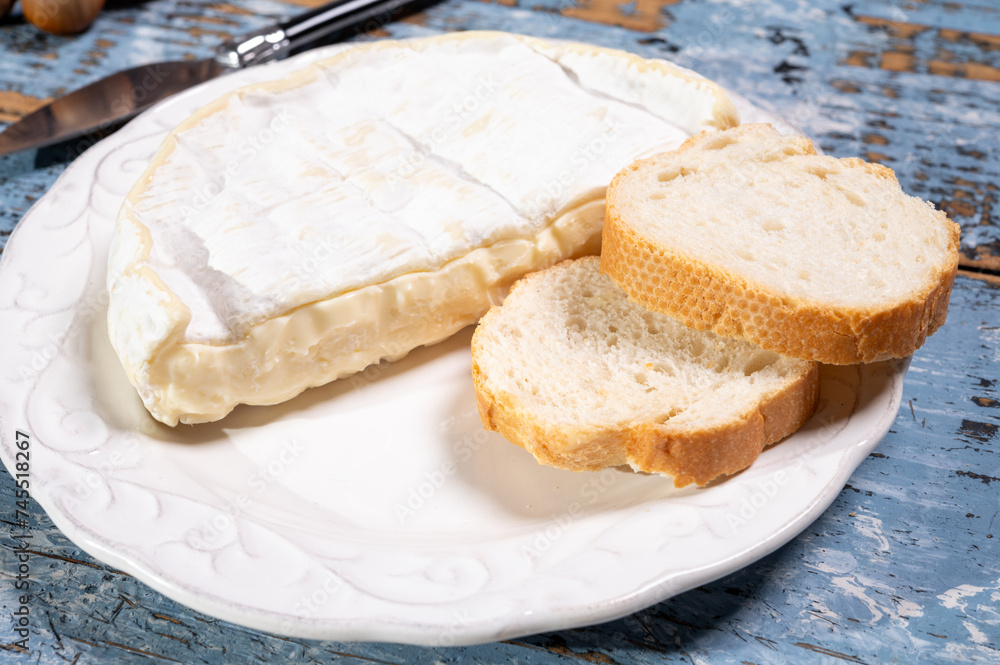 French soft Camembert cheese, original Camembert de Normandie, close up with white mold French soft Camembert cheese, original Camembert de Normandie, close up with white mold