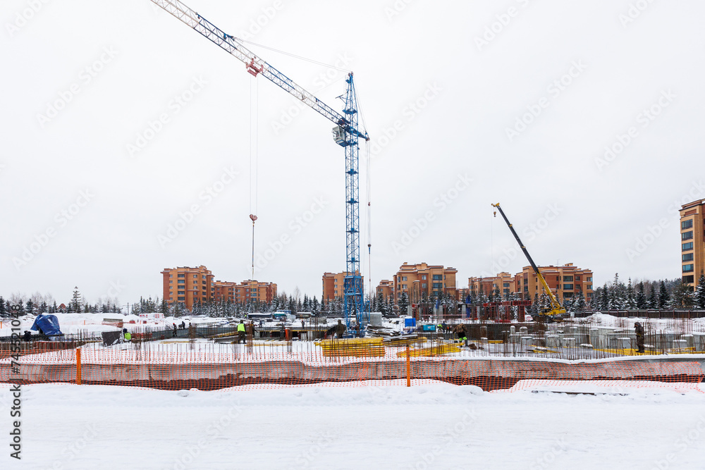 the construction site of an apartment building in the winter from a height