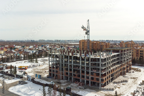 the construction site of an apartment building in the winter from a height