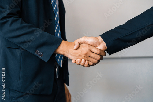 Business people agreement concept. Businessman do handshake with another businessman in the office meeting room. uds
