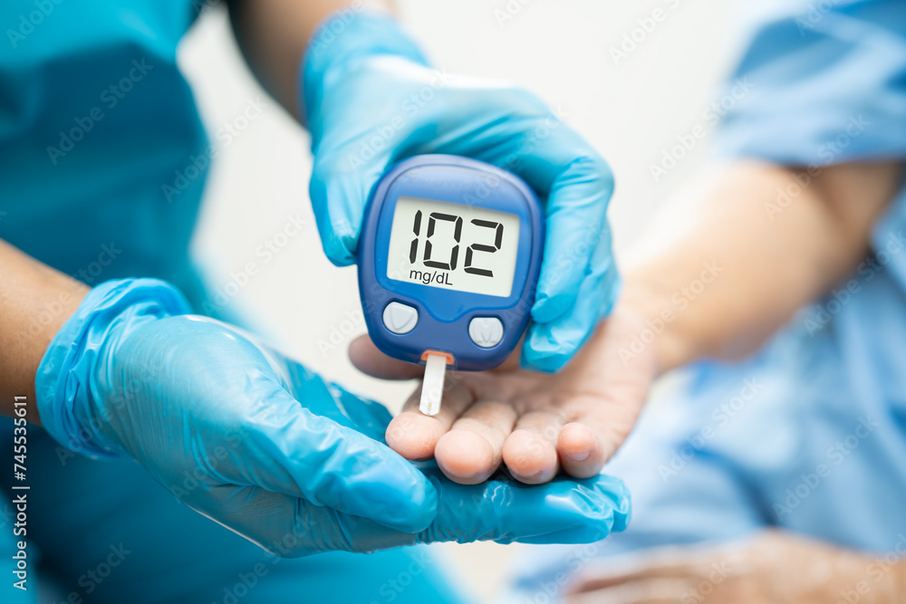 Doctor check diabetes from finger blood sugar level with finger lancet. Doctor check diabetes from finger blood sugar level with finger lancet.
