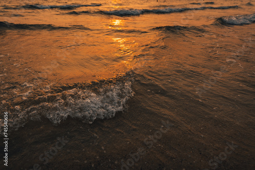 Sunset on the beach,Golden sea waves at sunset