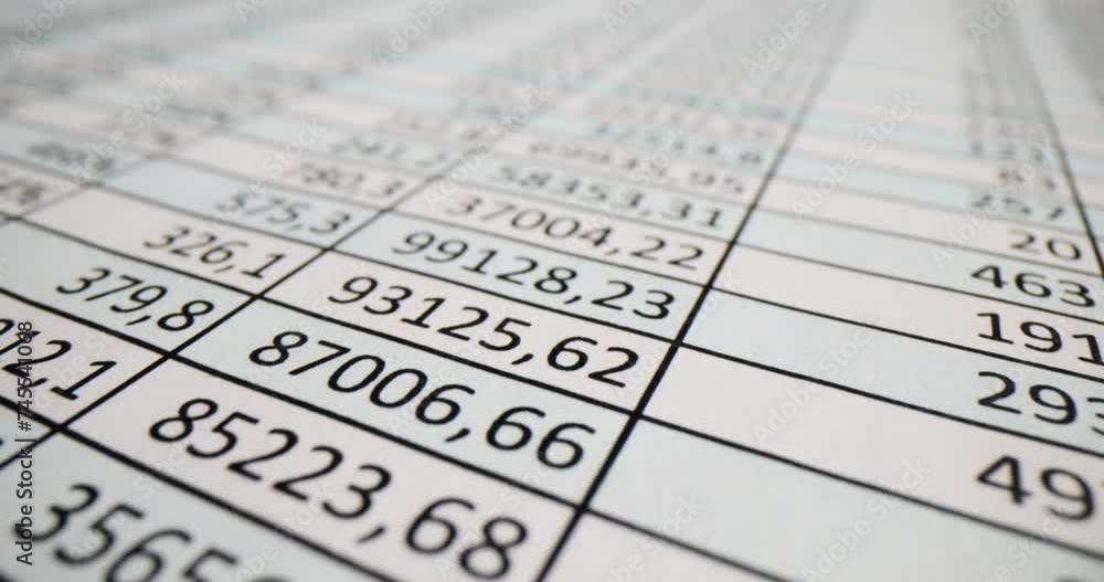 Document with columns of numbers on table in office Document with columns of numbers on table in office