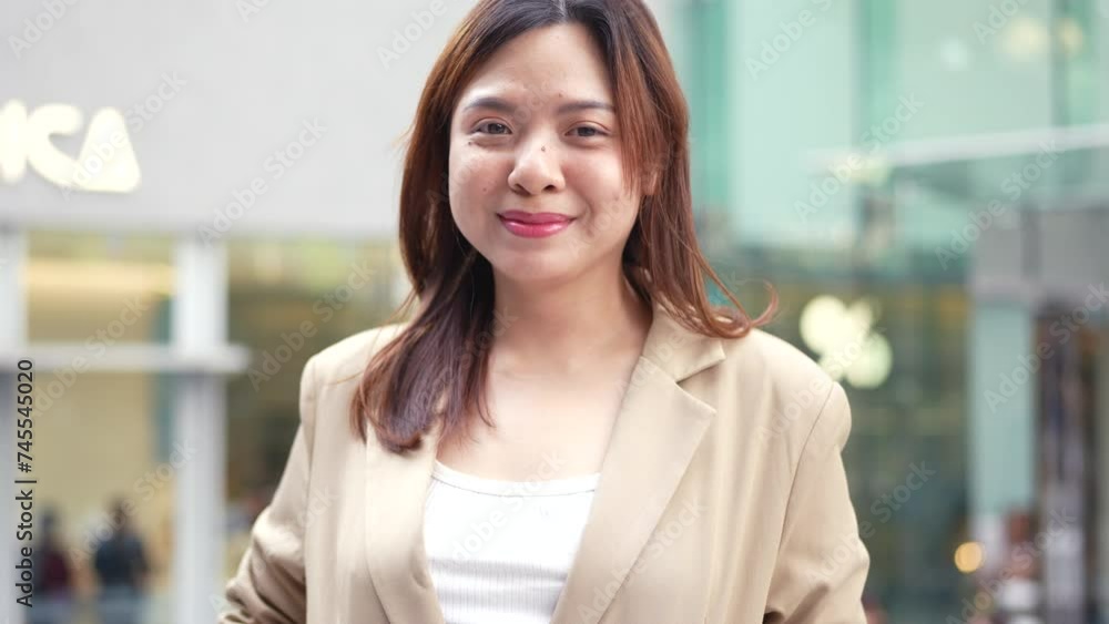 Smiling business asian woman standing on city office building modern asian business woman Smiling business asian woman standing on city office building modern asian business woman