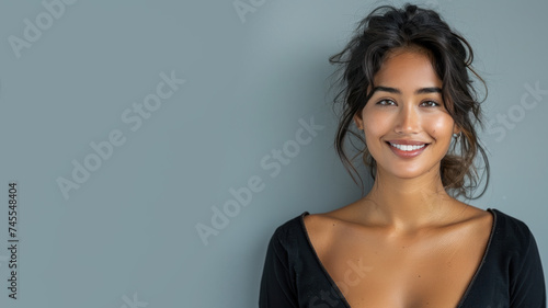 Indian woman wearing black ribbed V-Neck Body smiling isolated on grey