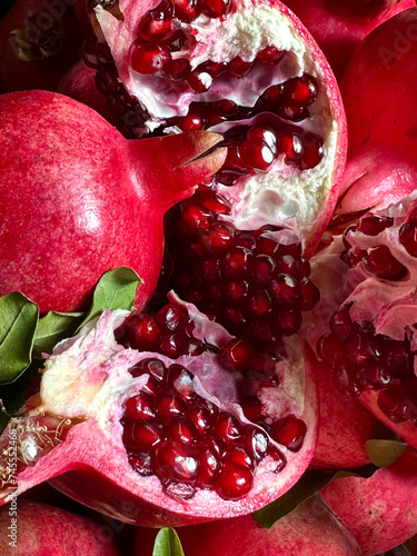 Cut ripe pomegranate with green leaves