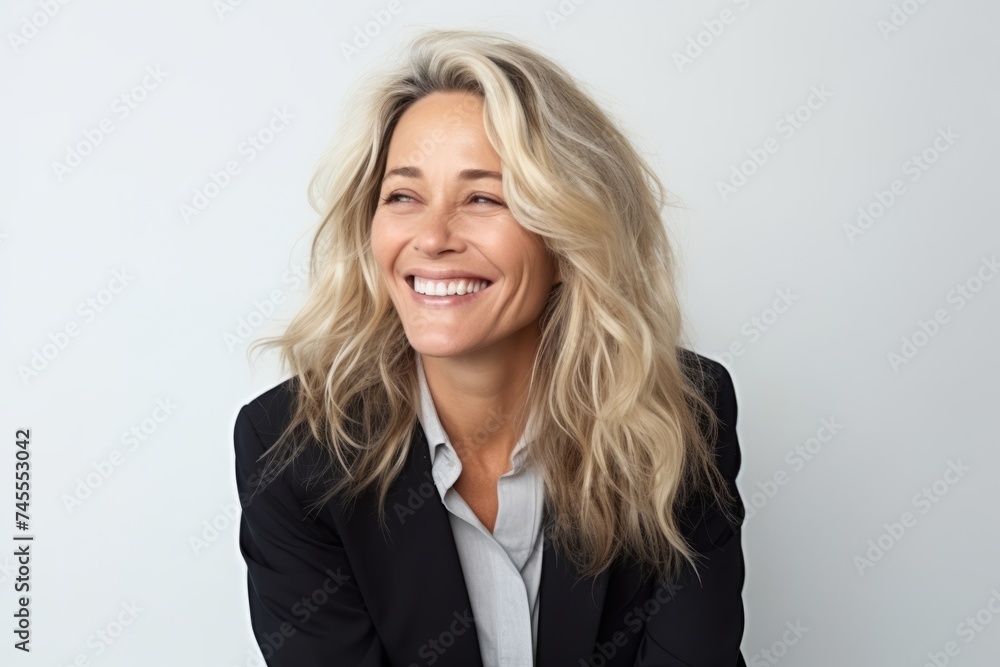 Portrait of a happy businesswoman smiling at the camera on grey background Portrait of a happy businesswoman smiling at the camera on grey background