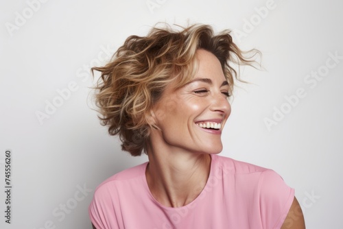 Portrait of happy young woman with blond hair. Studio shot.