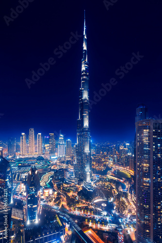 Night aerial top view of Dubai downtown skyscrapers with illuminated and highway. Business and financial modern district of city UAE
