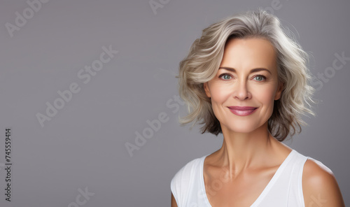 Portrait of a middle aged, mature, woman with white hair and beautiful skin. Concept of anti aging, cosmetics, skin care, beauty, plastic surgery, make-up. Copy space for text, advertising