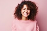Portrait of a happy young african american woman over pink background