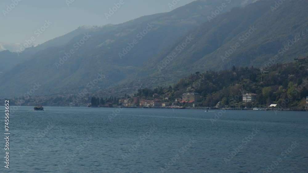 Lake Como With Foggy Mountains In View In Bellagio, Lombardy, Italy. wide shot Lake Como With Foggy Mountains In View In Bellagio, Lombardy, Italy. wide shot