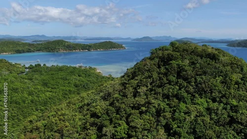 Wallpaper Mural Lush mountain and tropical forest along coast between El Nido and Coron Island with blue lagoon in background, Palawan area, Philippines. Aerial forward  Torontodigital.ca