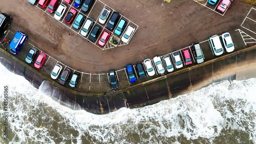 Stormy winter scene. Rough seas of the English coast with mist and fog. Aerial footage of the sleepy coastal town of Sandsend beach on the coast of north Yorkshire in England photo