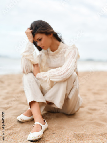 Beach Beauty: Attractive Caucasian Woman Relaxing Alone on Sandy Coastline, Enjoying a Sunny Summer Day near the Rock, with Gorgeous Sky and Blue Sea as the Background