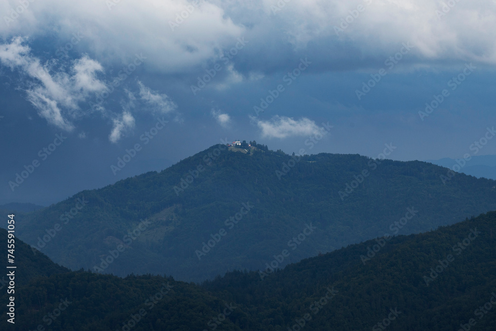 Dramatic clouds over small hiltop church in Slovenia. Dramatic clouds over small hiltop church in Slovenia.