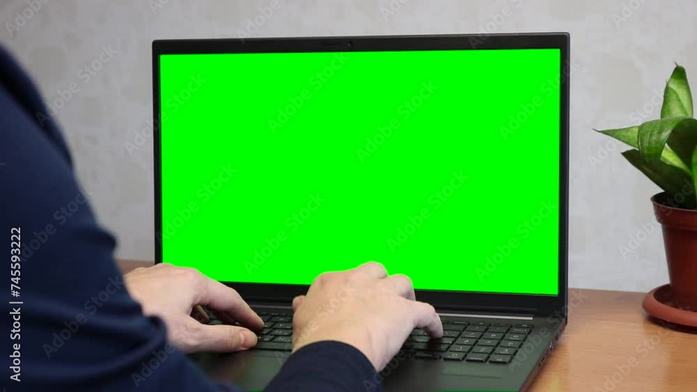 Persona user press keyboard on laptop with green screen chromakey mockup. Remote work concept. Persona user press keyboard on laptop with green screen chromakey mockup. Remote work concept.