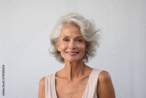Portrait of beautiful senior woman with short grey hair looking at camera