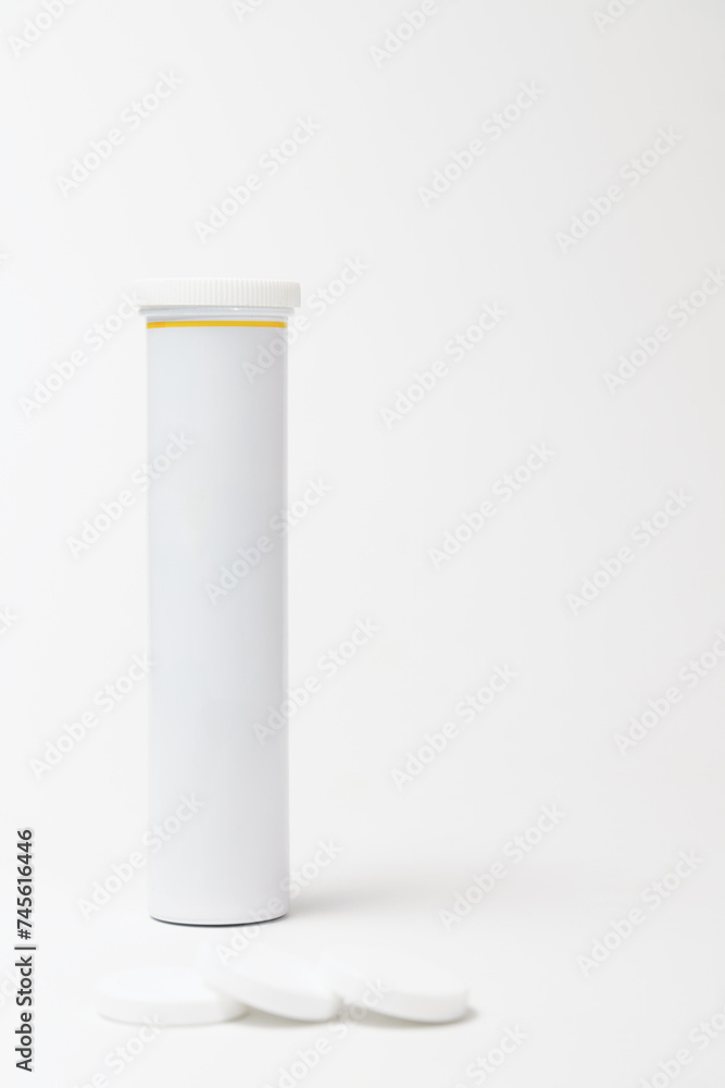 pill bottle in white, isolated on white background with blurred tablets and copy space pill bottle in white, isolated on white background with blurred tablets and copy space