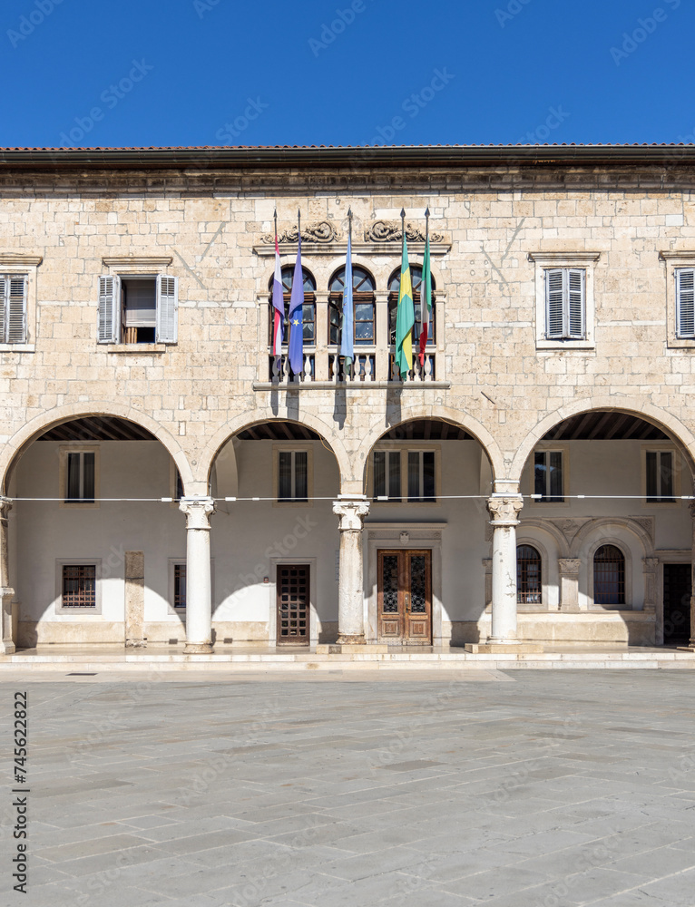 Pula, Croatia, Istria - September 29, 2023: Facade of Communal Palace located on the Forum Square. It is seat of local government