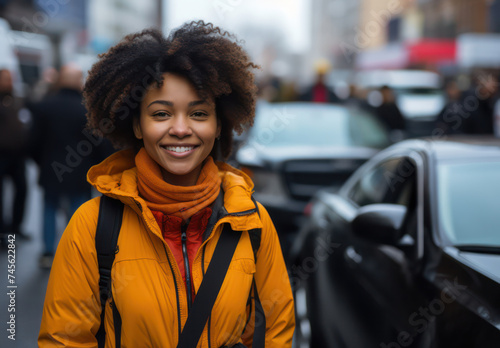 Happy Afro-American Woman, a Portrait of Youthful Beauty in the Urban Jungle: A Stylish and Cheerful Lady with Attractive Curly Hair, Laughing with Confidence on the Black Street, a Modern Model