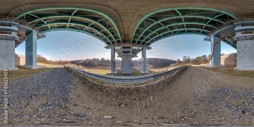 hdri 360 panorama on gravel road under steel frame construction of huge car bridge across river in equirectangular full seamless spherical projection. VR AR content