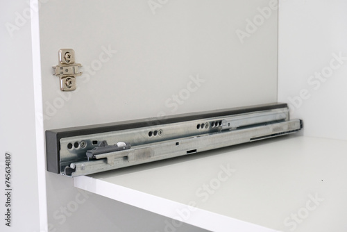 фотографія Drawer guide rail, mounted in a new kitchen cabinet.