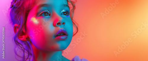 Fashion modern art cute young girl in colorful bright neon lights posing studio. Creative banner