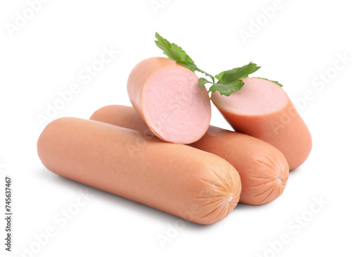 Whole and cut delicious boiled sausages with parsley on white background