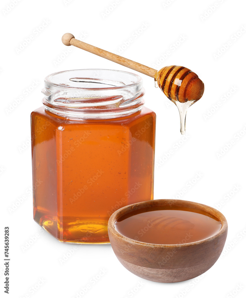 Natural honey dripping from dipper into wooden bowl. Jar full of honey on white background Natural honey dripping from dipper into wooden bowl. Jar full of honey on white background
