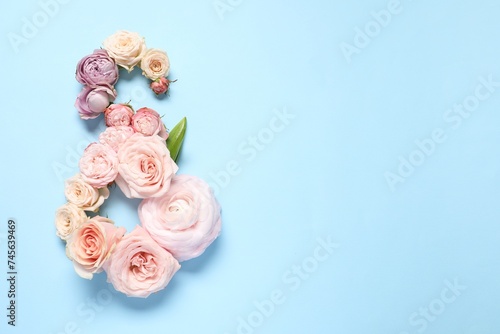 8 March greeting card design made with beautiful flowers on light blue background, top view. Space for text