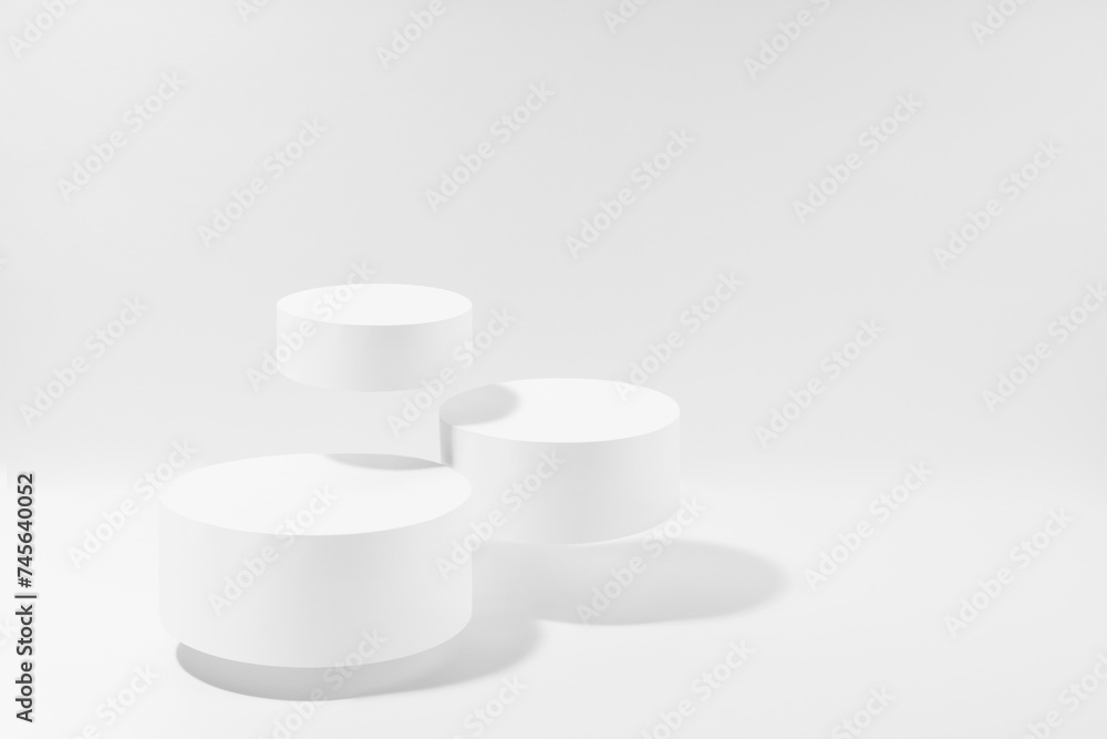 Three white round podiums levitate, mockup on white background with shadow. Template for presentation cosmetic products, gifts, goods, advertising, design, display, showing in elegant fashion style. Three white round podiums levitate, mockup on white background with shadow. Template for presentation cosmetic products, gifts, goods, advertising, design, display, showing in elegant fashion style.