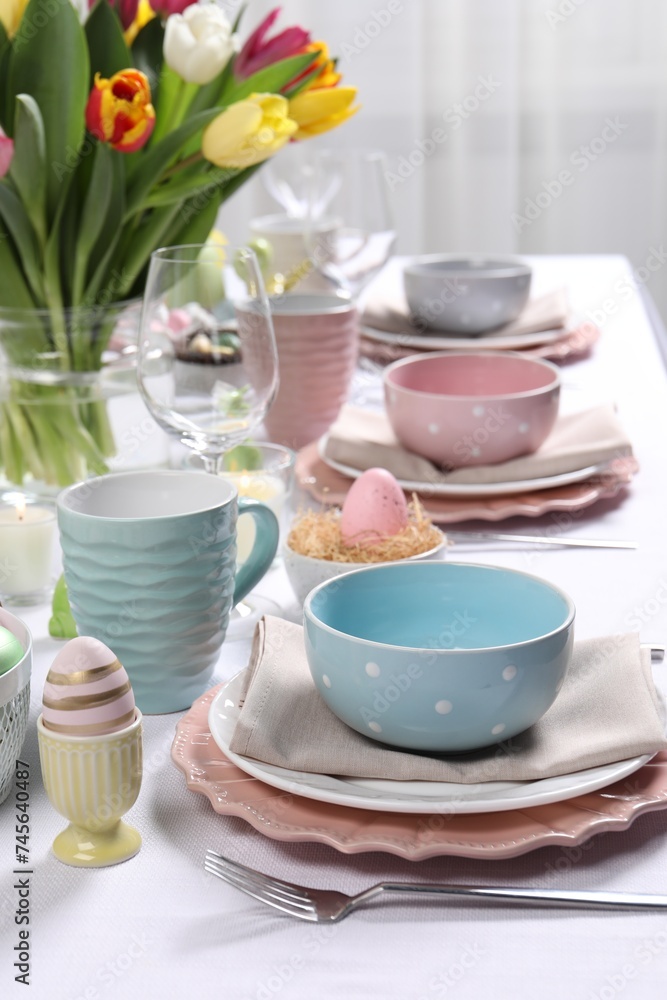 Festive table setting with beautiful flowers. Easter celebration Festive table setting with beautiful flowers. Easter celebration