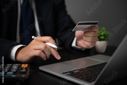 Online payment finance and banking concept. Businessperson using a credit card and a laptop for internet online purchases.