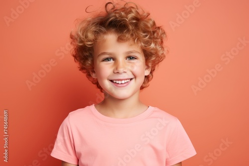 Portrait of a cute little girl with curly hair on a red background