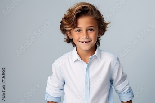 Portrait of a cute little boy in a blue shirt. Studio shot.