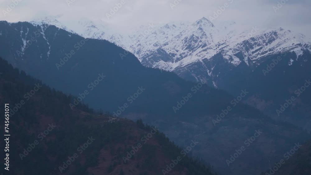 Snowy Himalayan mountain peaks after snowfall during the winter season at Manali in Himachal Pradesh, India. View of snowy mountain peaks after snowfall in winter. Natural Himalayas background.