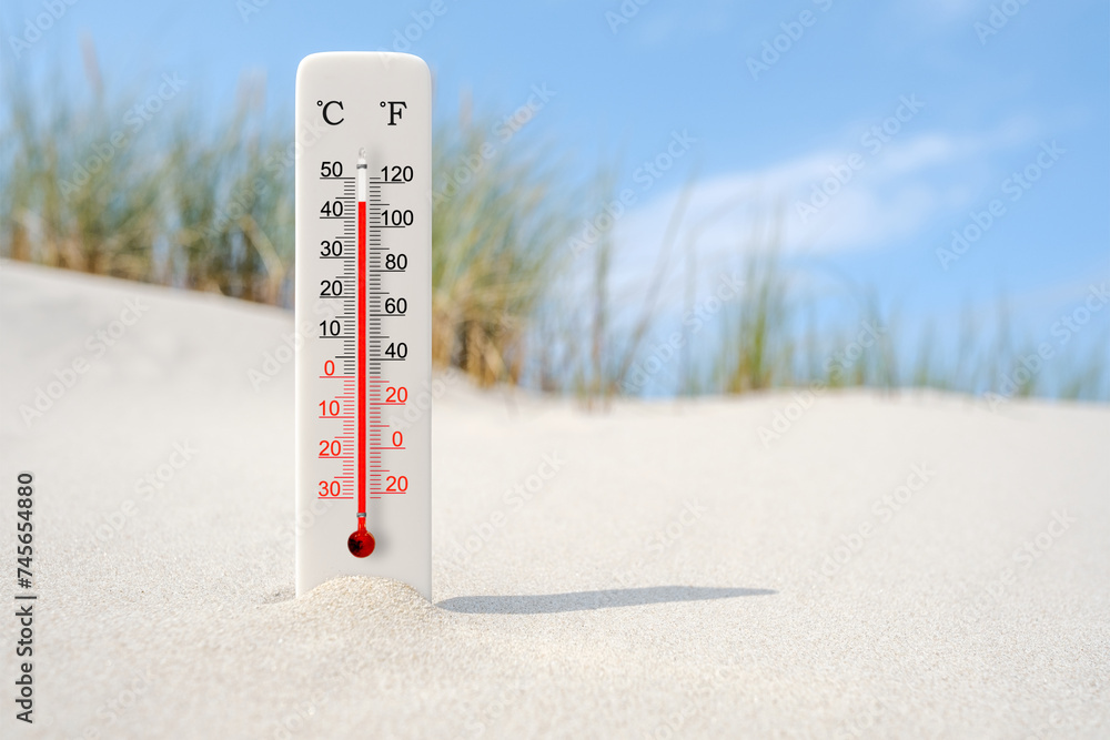 Hot summer day. Celsius and fahrenheit scale thermometer in the sand. Ambient temperature plus 44 degrees - obrazy, fototapety, plakaty 
