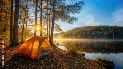 Camping and tent near lake in sunrise