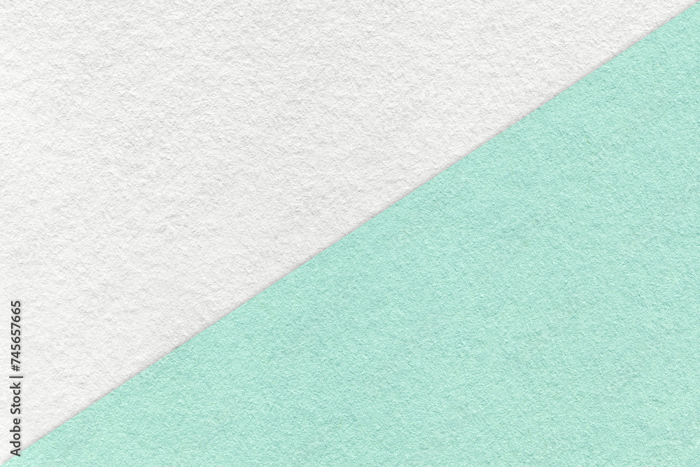 Fototapeta premium Texture of craft white and light cyan paper background, half two colors, macro. Vintage kraft mint cardboard.