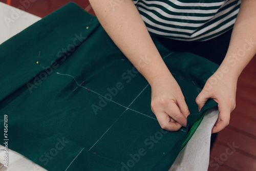 girl works on an embroidery machine at home, sets up and prepares the machine for work