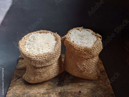 white rice in a gunni sack with a wooden board