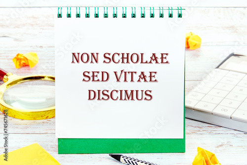 Non scholae sed vitae discimus It is translated from Latin as We study not for school, but for life. It is written on a standing notebook photo