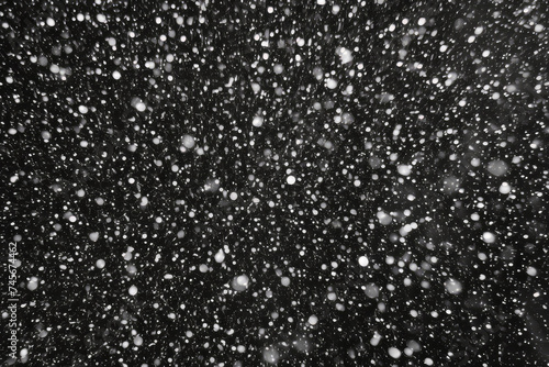 Black and white depiction of snow gently falling from the sky