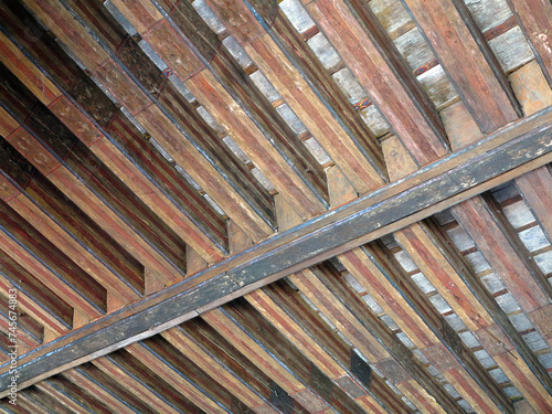 Aged beams in an old barn. Old roof achitecture detail. photo