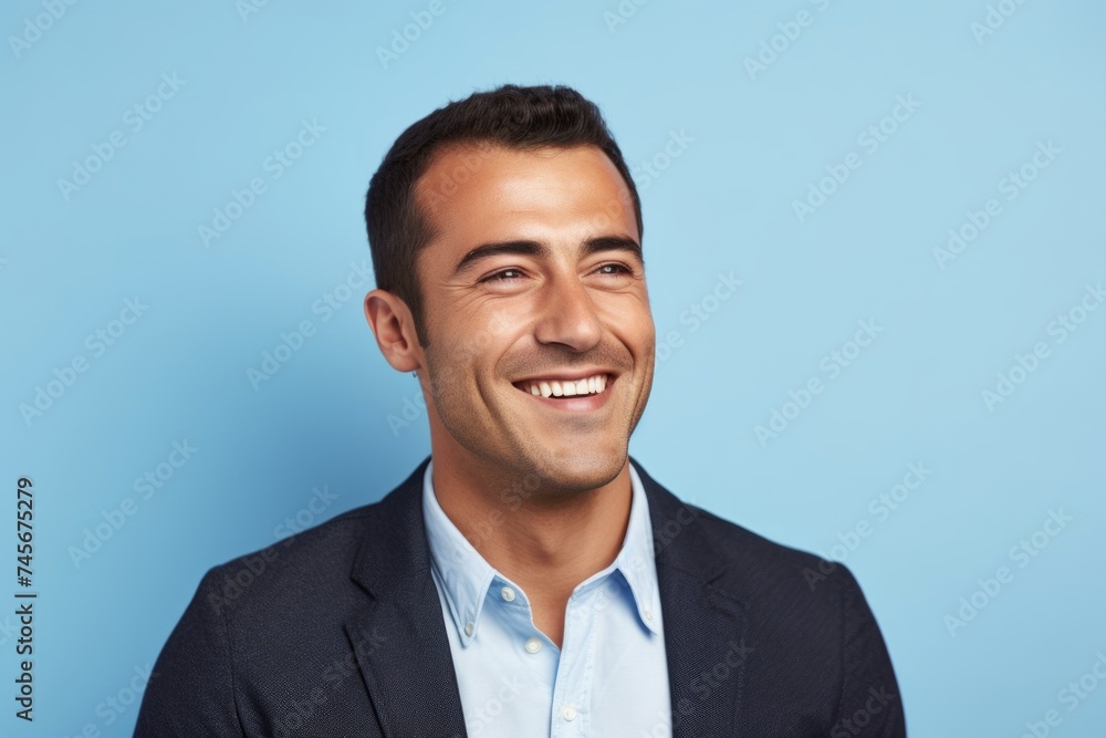 Portrait of happy smiling young businessman, isolated over blue background. Portrait of happy smiling young businessman, isolated over blue background.