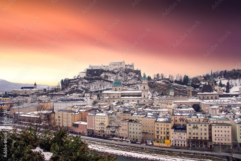 Salzburg with Festung Hohensalzburg and Salzach river in winter sunset, Austria